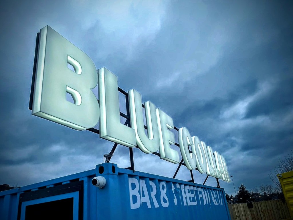 Blue collar projecting sign